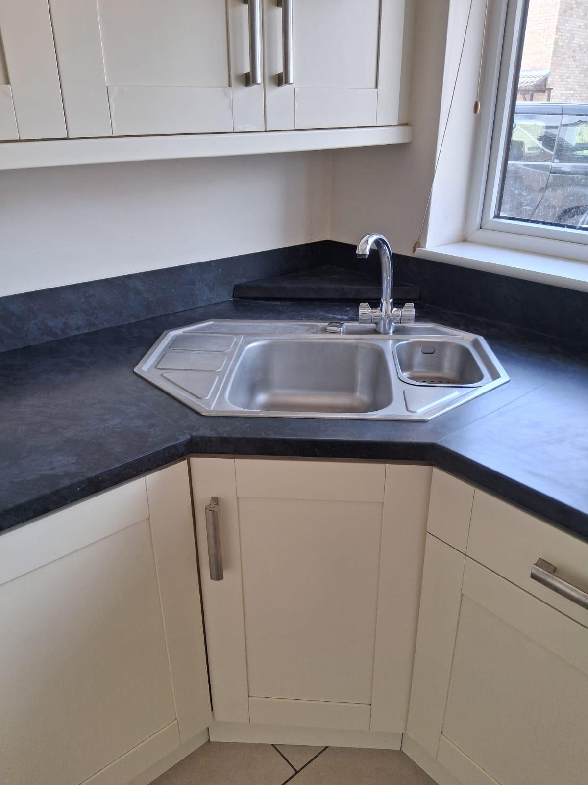 Kitchen sink and surrounding area after professional cleaning